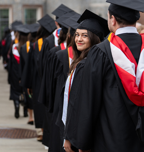 Students lined up in regalia for commencement