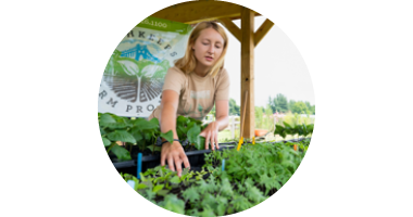 Image of student working in community garden.