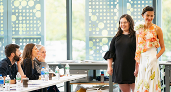 An image of fashion students presenting design work.