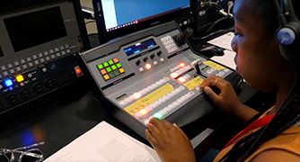 An image of a student working on a board. 