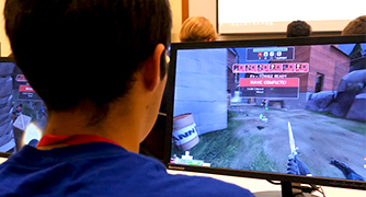 An image of a student playing a video game. 