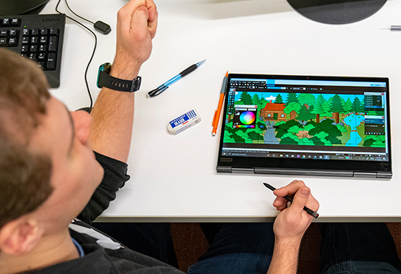 An image of a student working on game design.
