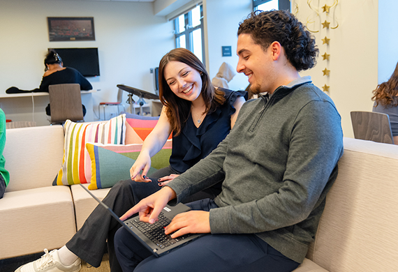 Image of two Marist students working on a lap top.