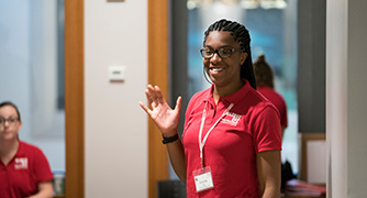 An image of a student waving. 