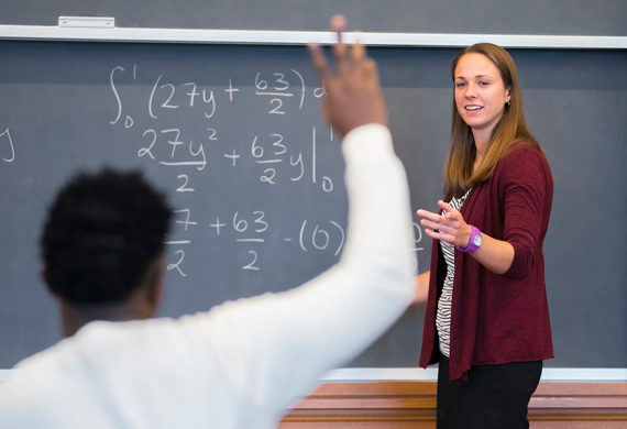 An image of a faculty member teaching in front of a class.