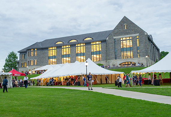 Image of people in tents on the Campus Green outside the library. 