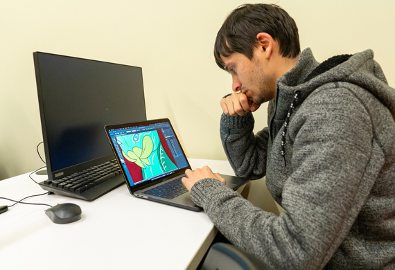 Image of a student working on a graphic design project.