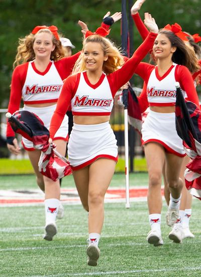 Cheerleaders running onto the field at Tenney Stadium