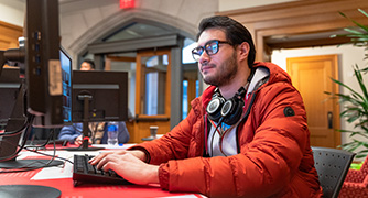 Image of Marist University student sitting at computer.