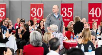 Image of Marist University staff member being recognized at a campus event.