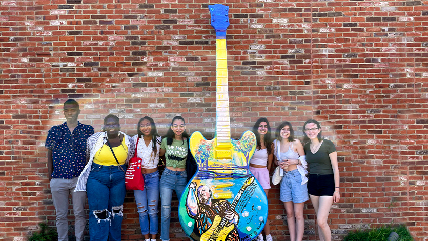 The students with artwork at the Stax Musuem of American Soul Music in Memphis, TN.  Photo courtesy of Dr. Robyn Rosen 