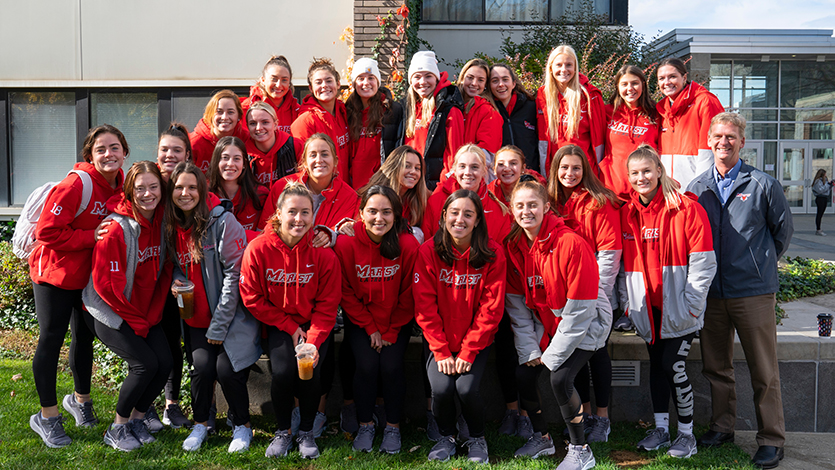 image of president weinman Taking a photo with the Marist Women’s Lacrosse team at the 2021 Hunger Walk