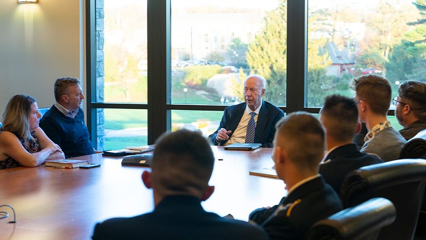 image of: David Gergen (center) meets with ROTC students and faculty/staff veterans.