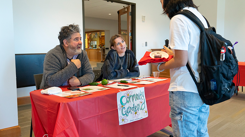 image: Dr. Joseph Campisi (far left) speaking to a student about the Marist College Community Garden during the 2022 Non-Profit Information Fair