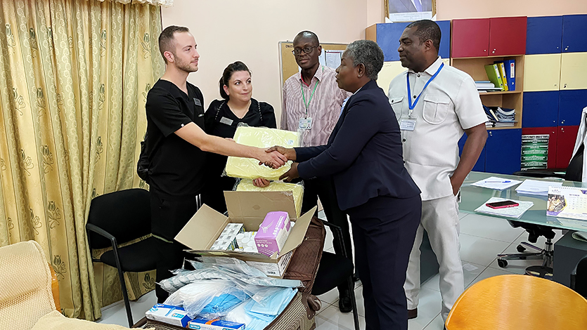 Image of Ryan Morris and Caitlin Conner with colleagues and medical supplies collected through their donation drive.