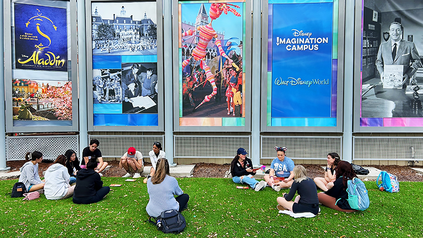 Image of students in groups outside of the Disney Imagination Campus. 