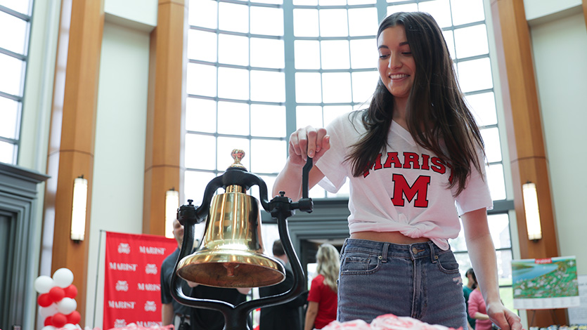 Image of student ringing deposit bell. 