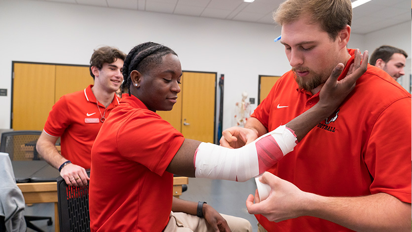Image of Athletic Training students practice taping and wrapping in the Athletic Training Lab.