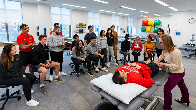 Image of Doctor of Physical Therapy students observe a technique during a class at the DPT Skills Lab. 