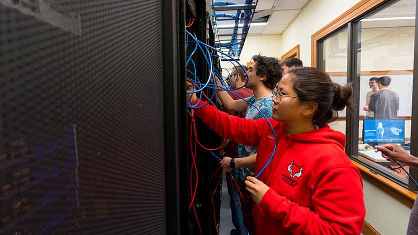 Image of Students in the School of Computer Science and Mathematics in the Networking Lab at the Hancock Center.
