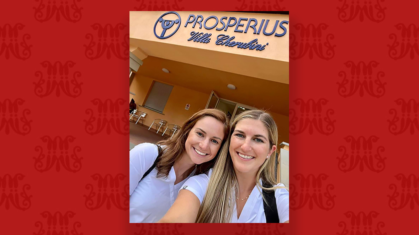 Image of Kelly Boonie (left) and Mary Smyth (right) standing in front of the entrance to their clinic in Fiesole, Italy.