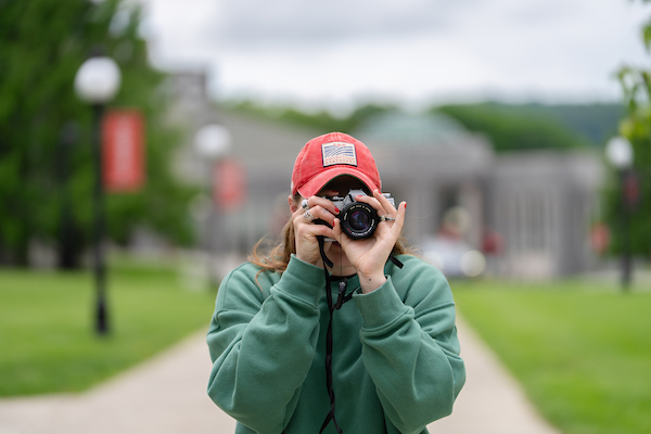 Image of Marist student taking a picture.