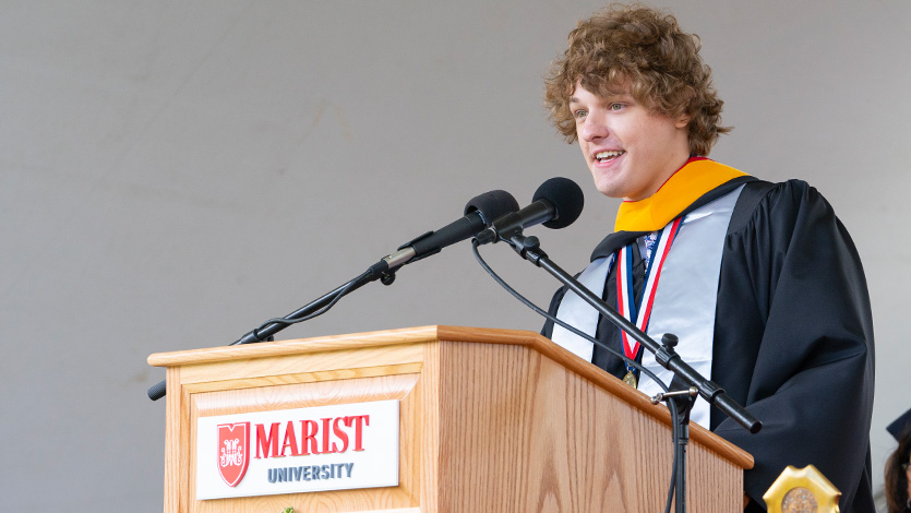 Image of student speaker Evan Spillane '25 addressing graduates at commencement.