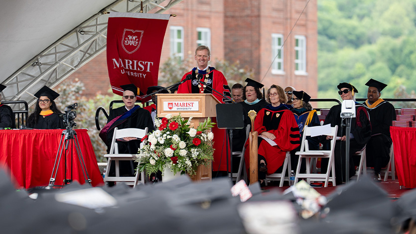Image of President Weinman addressing graduates at commencement.