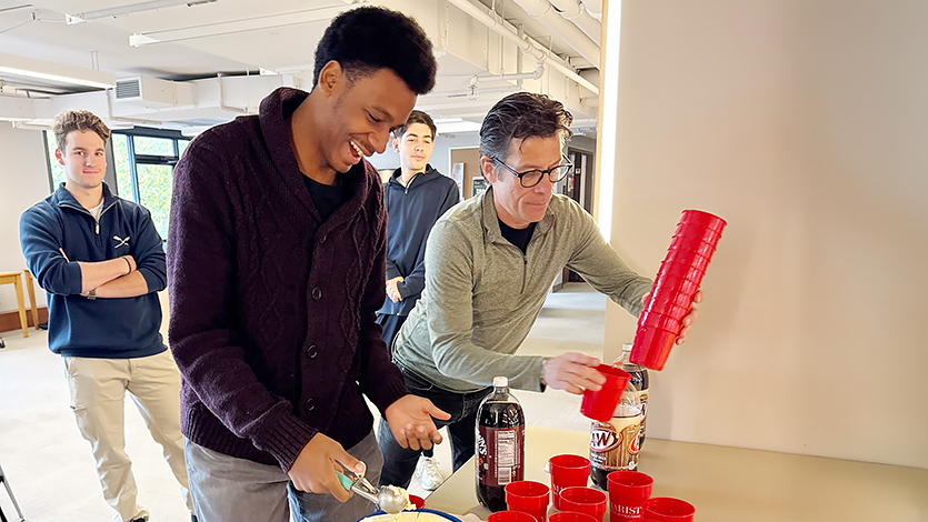 Image of Colin McCann and commuter student making root beer floats. 