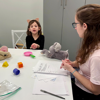 Image of a student and child working in the BLOSSOM Lab.