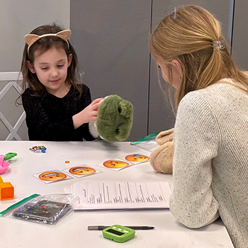 Image of a student and child working in the BLOSSOM Lab.