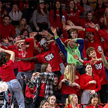 Image of students cheering at a basketball game.