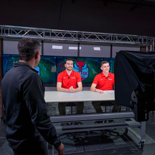 Image of communication students taping an episode of the Red Fox Report.