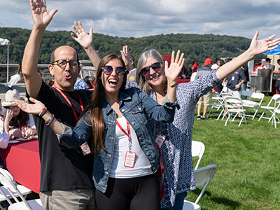 Photo of a student and her parents at Family Weekend