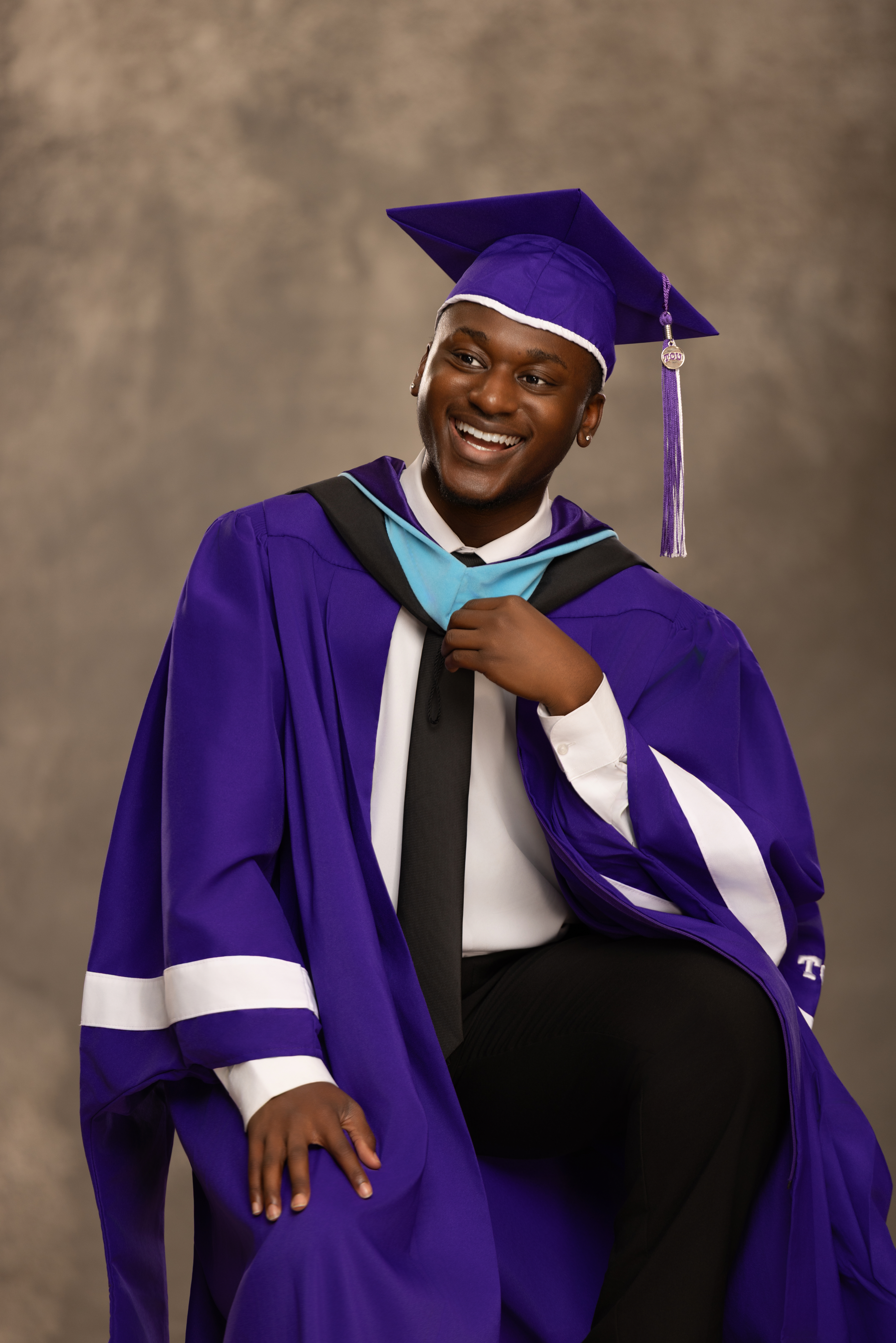 Image of Coordinator Gus Cobba in graduation regalia