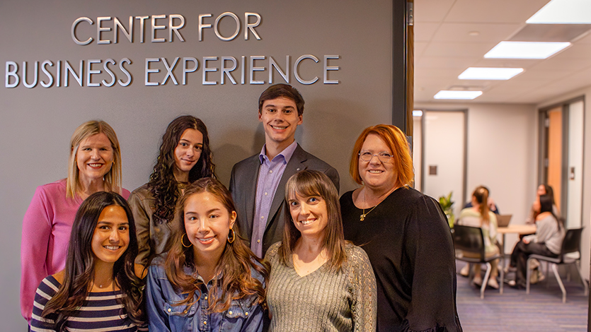 Image of Katie Giordano (back row, far left), Michele Williams (front row, far right), and Heather Hallenbeck (back row, far right) pose in front of the center with SOM students. Photo by Alyssa Walrad/Marist University.