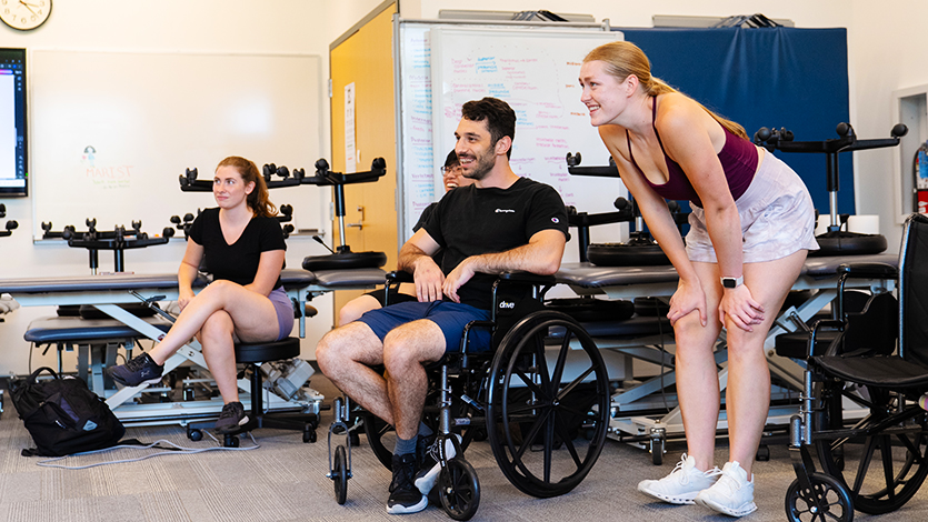 Image of DPT students taking turns learning about wheelchair exercise. 