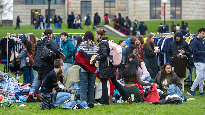 Image of students sorting through clothes to thrift at the Ethical Fashion Initiative’s Fashion Fest on the Green. Photo by Emily Portnov ‘27/Marist University.