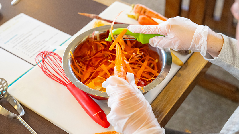 Image of Students peel brightly colored carrots to form the base of their rainbow ribbon carrot salad. Photo by Carlo de Jesus/Marist University.