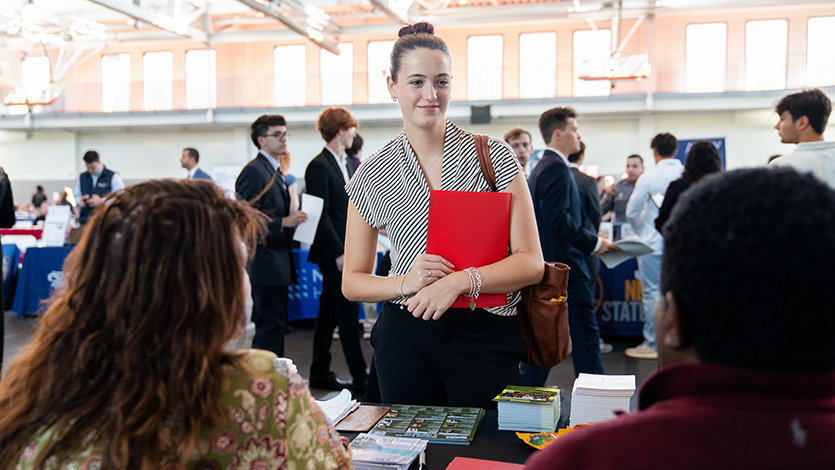 Image of student talking with recruiters at Fall 2026 Career and Internship Fair