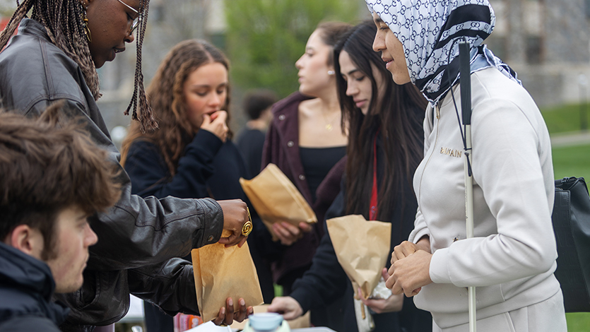 Image of students making homemade granola at the Earth Fair on the Green. Photo by Emily Portnov ’27 /Marist University. 