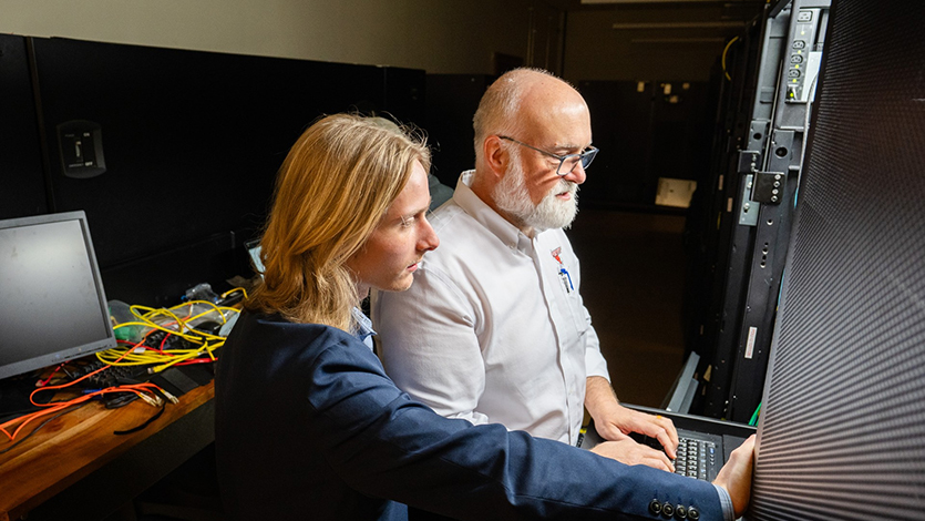 Image of Noah Yurasko and Professor Chris Algozzine working in the Enterprise Computing Research Lab