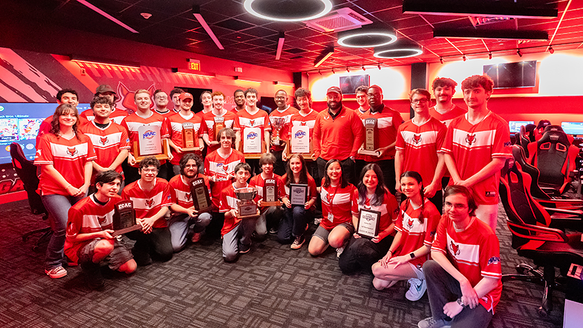 Image of esports teams holding their trophies in the new Esports Lab.