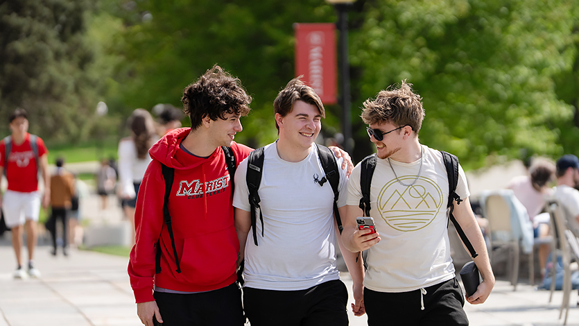 Image of three students outside James A Cannavino Library.