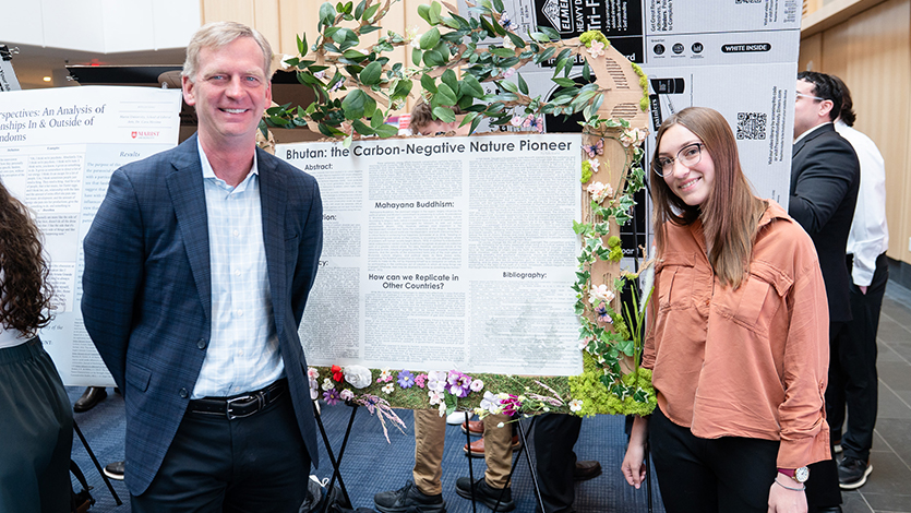 Image of Kate Krehel ’28 presents her research project to President Kevin Weinman. Photo by Nelson Echeverria/Marist University.