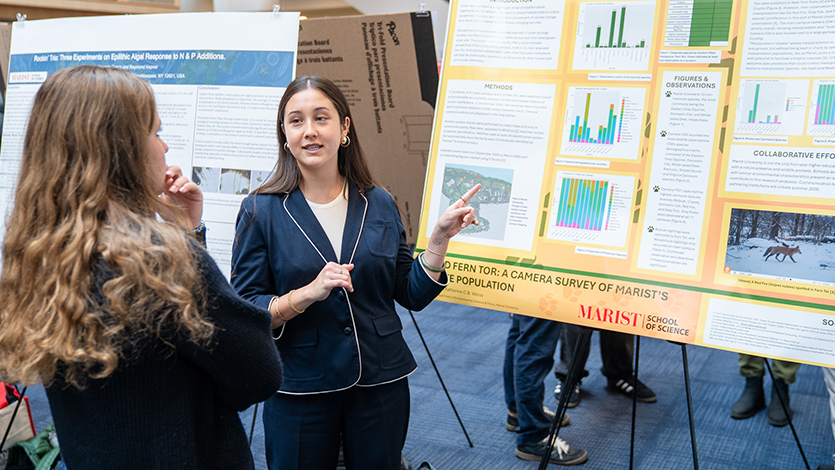 Image of A student asking Brooklyn Jones ’26 about her research presentation. Photo by Nelson Echeverria/Marist University.