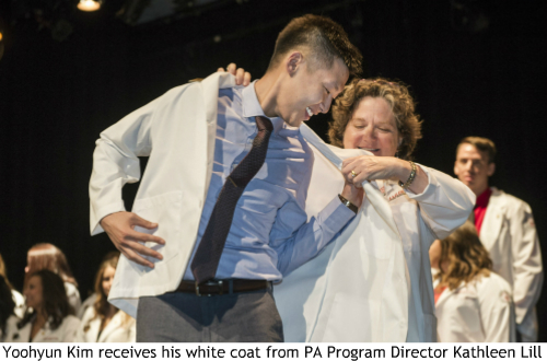 An image of Yoohyun Kim receiving his white coat from PA Program Director Kathleen Lill