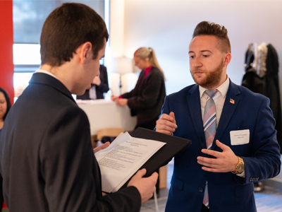 Image of an alum networking with a Marist University student in the career services office.