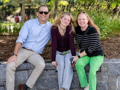 Image of a family sitting on the Marist University campus.