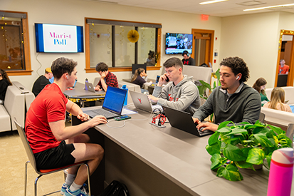 Image of a group of Marist University students in the Marist Poll suite.